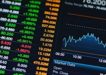 Stock market data on a digital screen with fluctuating numbers